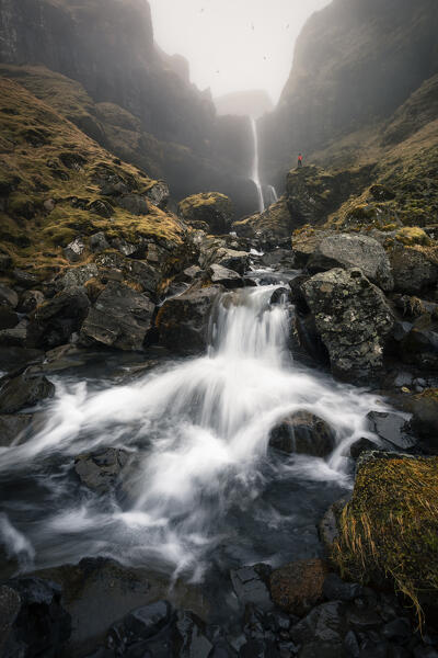 A man at Bugsfoss waterfall, Olafsvik, Snaefellsnes peninsula, Vesturland region, Iceland, Northern Europe