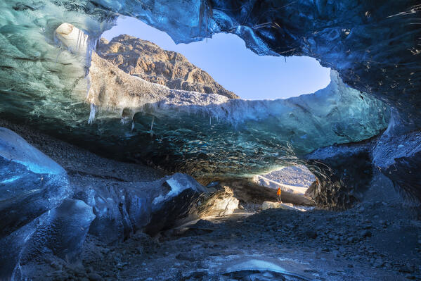 Man in an ice cave of Breidamerkurjokull, Austurland, Iceland, Northern Europe
