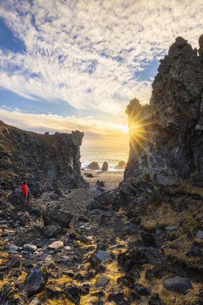 A man st Dritvik and Djúpalónssandur during sunset, Hellnar, Snaefellsnes peninsula, Vesturland region, Iceland, Northern Europe