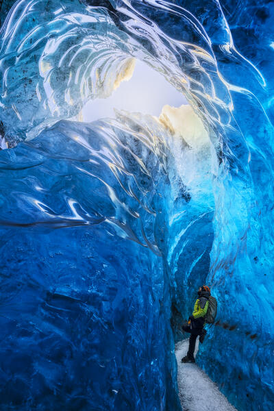 Man in an ice cave of Breidamerkurjokull, Austurland, Iceland, Northern Europe