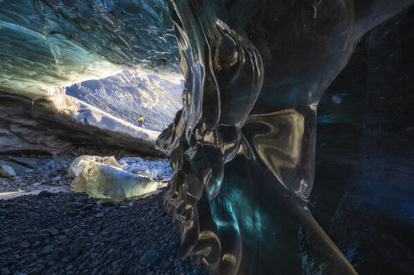 Man in an ice cave of Breidamerkurjokull, Austurland, Iceland, Northern Europe