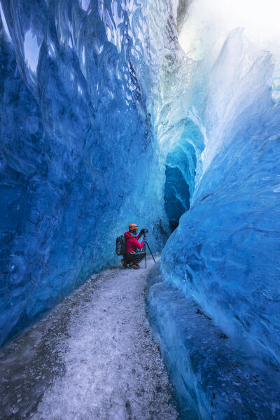 Man in an ice cave of Breidamerkurjokull, Austurland, Iceland, Northern Europe