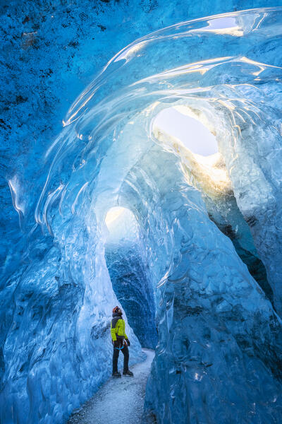 Man in an ice cave of Breidamerkurjokull, Austurland, Iceland, Northern Europe (MR)