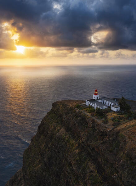 A warm light envelope the beautiful Farol da Ponta do Pargo during sunset, Madeira, Portugal, Western Europe