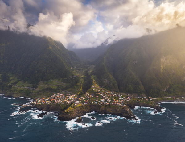 Aerial view taken from a drone of the coast of Seixal during sunset with warm enveloping light, Madeira Portugal Western Europe