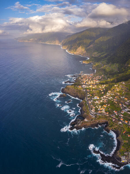 Aerial view taken from a drone of the coast of Seixal during sunset with warm enveloping light, Madeira Portugal Western Europe