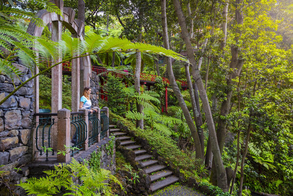 A woman observes the Monte Palace Tropical gardens of Madeira, Santa Maria Maior, Funchal, Madeira island, Portugal, Europe