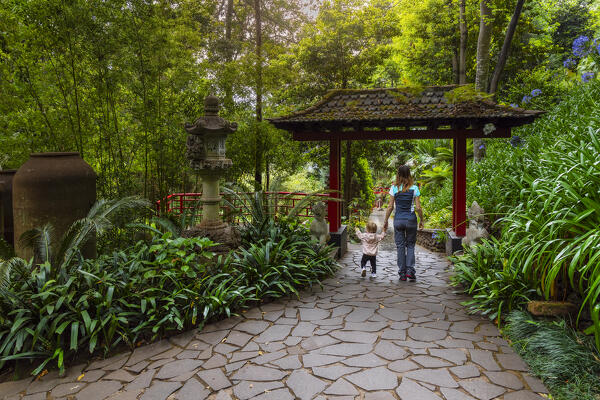 A woman and her daughter are walking inside the Monte Palace Tropical gardens of Madeira, Santa Maria Maior, Funchal, Madeira island, Portugal, Europe