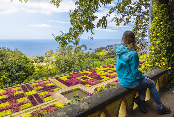 A woman observes the Botanical garden of Madeira, Santa Maria Maior, Funchal, Madeira island, Portugal, Europe