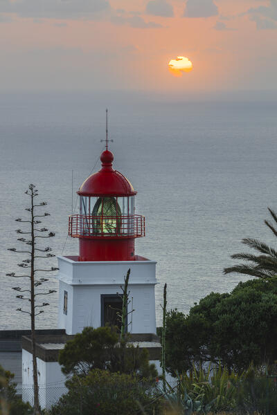A warm light envelope the beautiful Farol da Ponta do Pargo during sunset, Madeira, Portugal, Western Europe
