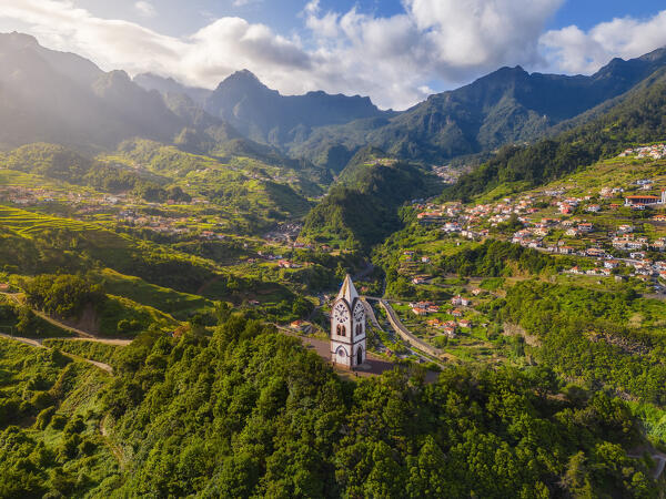 Aerial view of Capelinha de Nossa Senhora de Fatima surrounded by terraced fields at sunrise, Sao Vicente, Madeira, Portugal, Europe