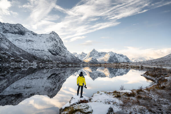 A photographer observes reflections of mountains in Storvatnet near Vareid, Flakstad, Moskenesoya, Nordland, Lofoten Islands, Norway, Northern Europe (MR)