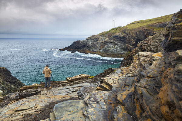 A photographer at Trevose Head lighthouse, St Merryn, Padstow, Cornwall, England, Great Britain, United Kingdom