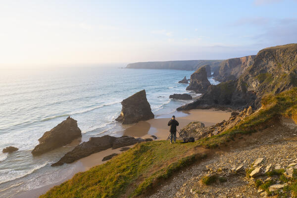 Aerial view at Sunset of a photographer at Carnewas and Bedruthan Steps, Bedruthan Steps, Newquay, Cornwall, United Kingdom, Northern Europe