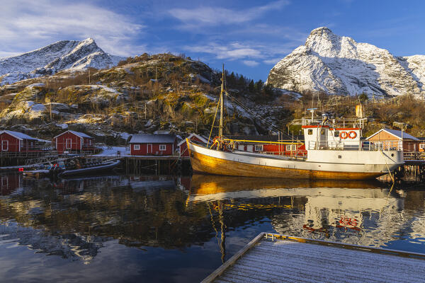 Reflections, boats and Rorbuer in Nusfjord during winter, Flakstad, Flakstadoya, Nordland, Lofoten Islands, Norway, Northern Europe