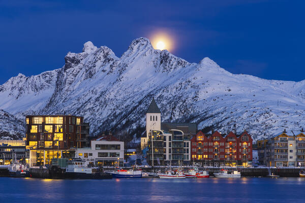 Illuminated skyline of Svolvaer with full moon during blue hour, Vagan, Austagoy, Nordland, Lofoten, Norway, Northern Europe 