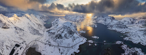 Panoramic and Aerial view of Fredvang bridges E10 and mpuntains surrounding fjords during sunset in winter season, Fredvang, Flakstad, Moskenesøya, Nordland, Norway, Northern Europe