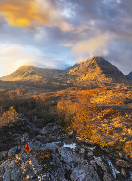 Aerial view of a tourist and mountains at Glencoe during sunrise, Highlands, Scotland, United Kingdom 