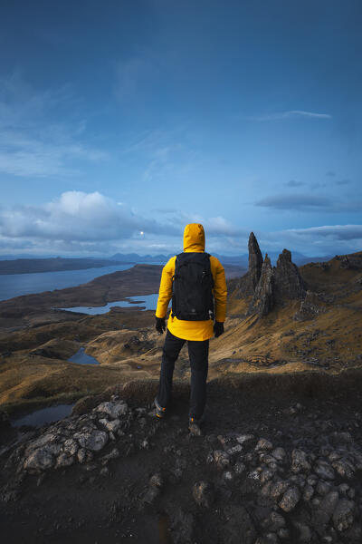 Tourist at Old Man of Storr during blue hour, Isle of Skye, Inner Hebrides, Trotternish peninsula, Highlands, Scotland, United Kingdom