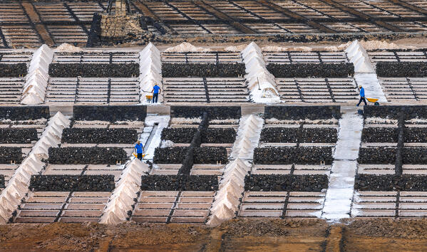 Workers at Salinas de Janubio viewed from mirador during sunset, Yaiza, Las Palmas, Timanfaya National Park, Lanzarote, Canary Islands, Macaronesia, Spain, Western Europe