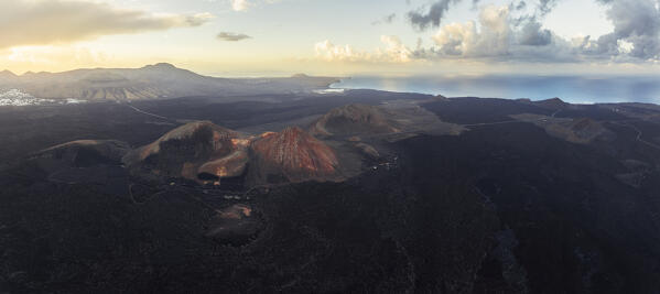 Aerial an panoramic view of El Nesto e Punta de Puerto Rimedio in the Timanfaya National Park at sunrise, Yaiza, Tinajo, Las Palmas, Lanzarote, Canary Islands, Macaronesia, Spain, Western Europe