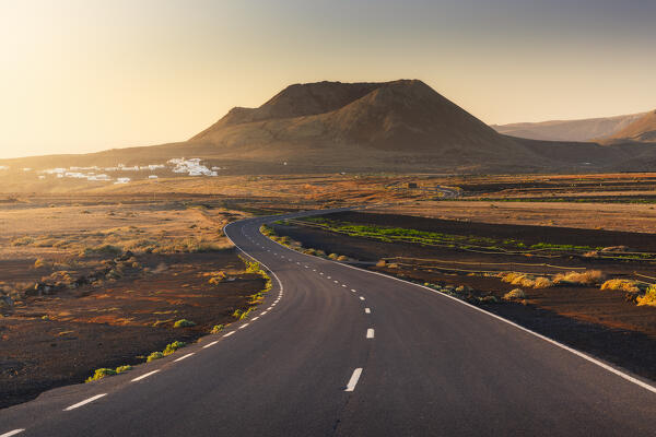 The road that leads to the crater of Volcan de la Corona in the background during sunrise, Mirador del Rio, Haria, Las Palmas, Lanzarote, Canary Islands, Macaronesia, Spain, Western Europe