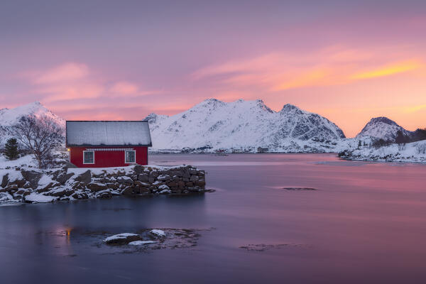 House and mountains at Ballstad village during sunrise, Vestvagoy, Nordland, Lofoten Islands, Norway, Northern Europe