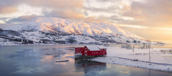 Aerial and panoramic view of house mountains and fjord at Austre Kanstad during winter sunset, Lodingen, Nordland, Lofoten Islands, Norway, Northern Europe