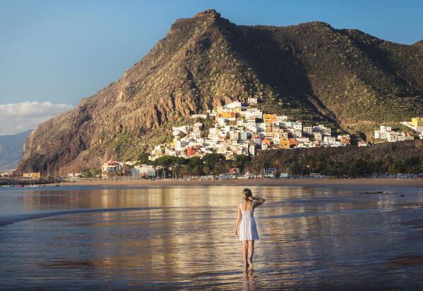 A tourist walks at Las Teresitas beach during sunrise, San Andres, Santa Cruz de Tenerife, Tenerife, Canary Islands, Macaronesia, Spain, Western Europe