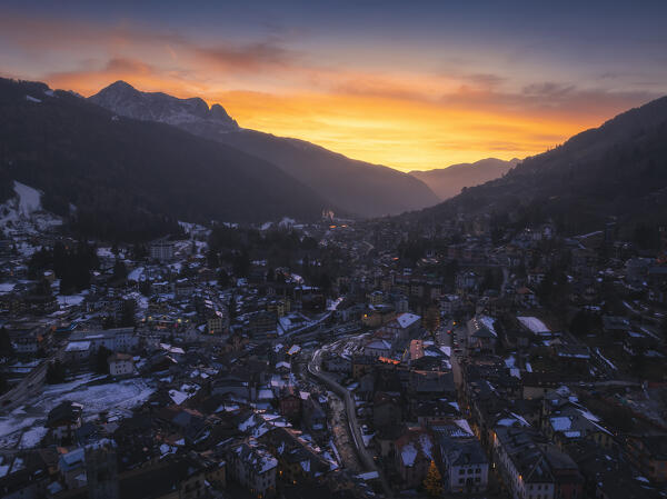 Aerial view of illuminated Ponte di Legno at dusk with mountains in the background during winter, Ponte di Legno, Brescia, Lombardia, Italy, Southern Europe