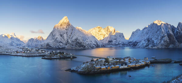 Aerial and Panoramic view of houses around Sakrisoy and Hamnoy at sunrise with Olstinden in the background, Hamnoy, Moskenes, Moskenesoya, Nordland, Lofoten, Norway, Northern Europe