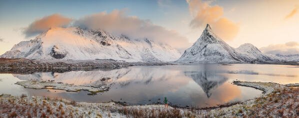 Aerial and panoramic view of a photographer in front of Fredvang mountains at sunset during winter, Fredvang, Flakstad, Moskenesøya, Nordland, Norway, Northern Europe