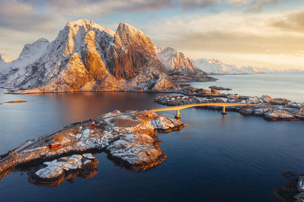 Aerial view of road over Sakrisoy and Hamnoy at sunrise with Feshelltinden in the background, Hamnoy, Moskenes, Moskenesoya, Nordland, Lofoten, Norway, Northern Europe