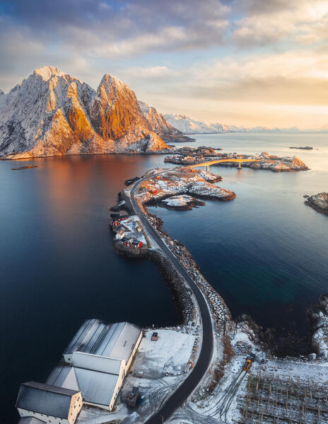 Aerial view of road over Sakrisoy and Hamnoy at sunrise with Feshelltinden in the background, Hamnoy, Moskenes, Moskenesoya, Nordland, Lofoten, Norway, Northern Europe