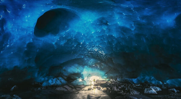 Panoramic view of a trekker inside an ice cave of Morteratsch glacier during winter, Bernina Valley, Grigioni, Switzerland, Western Europe