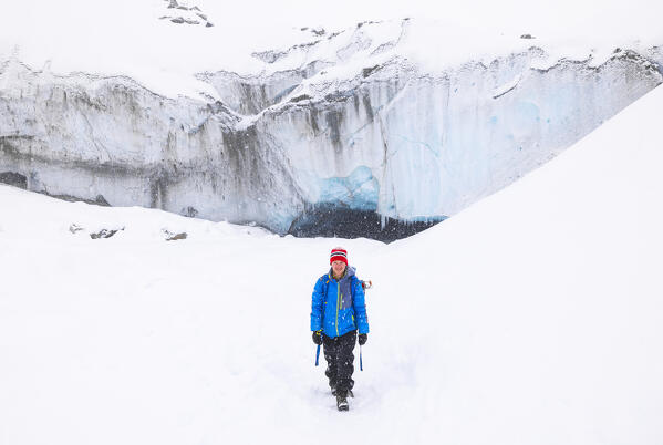 A trekker walks in the snow at Morteratsch glacier during winter, Bernina Valley, Grigioni, Switzerland, Western Europe