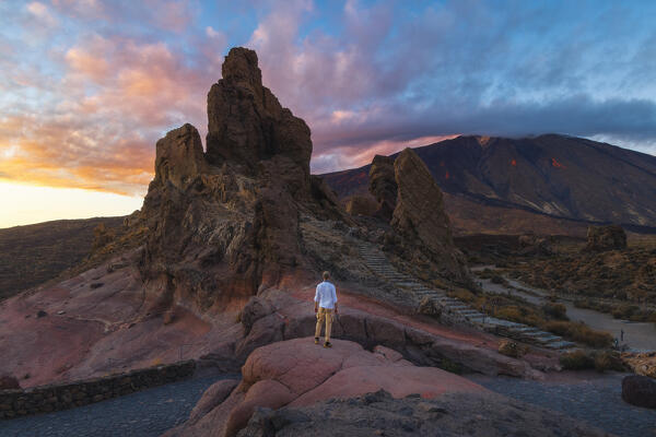 A tourist observes Roques de Garcia and Teide at sunset, Teide National Park, La Orotava, Santa Cruz de Tenerife, Tenerife, Canary Islands, Macaronesia, Spain, Western Europe
