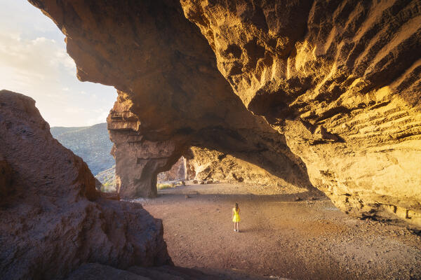 A tourist observes Cueva Roja at sunset, Santa Cruz de Tenerife, Tenerife, Canary Islands, Macaronesia, Spain, Western Europe