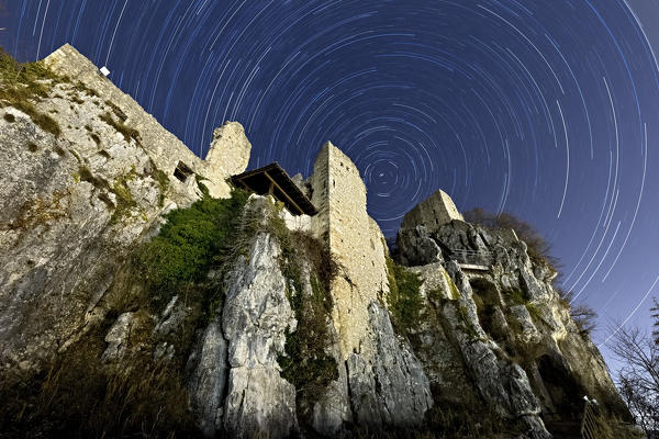 Star trail at Corno Castle in Isera. Trento province, Trentino Alto-Adige, Italy, Europe.