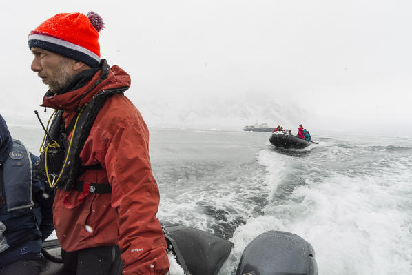 Tourists in inflatable boat, Wilhelmina Bay, Antarctica.