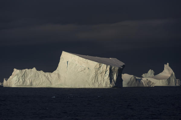 Icebergs under a stormy sky, Lemaire channel, Antarctica.