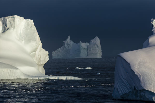 Icebergs under a stormy sky, Lemaire channel, Antarctica.