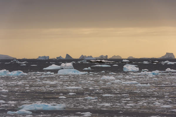 Icebergs at sunset in the Lemaire channel, Antarctica.