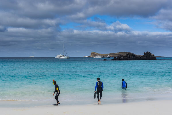 Tourist boats and people snorkeling in Gardner Bay, Espanola Island, Galapagos islands, Ecuador.