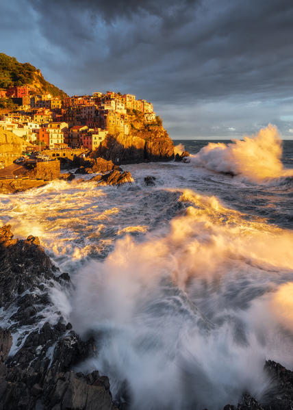 Storm at sunset on the cliff of the village of Manarola, Cinque Terre National Park, municipality of Riomaggiore, La Spezia province, Liguria district, Italy, Europe
