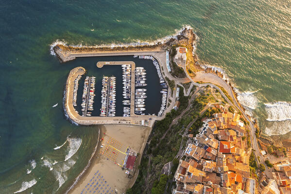Golden hour aerial view over the roofs of the old sea village of Sperlonga with the tower and the marina, Sperlonga, Latina province, Latium, Central Italy, Italy, Europe