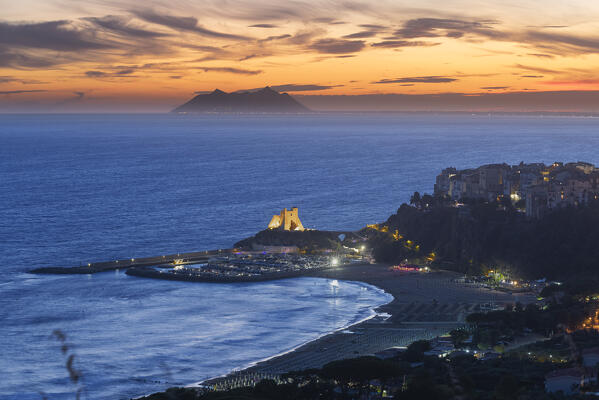 Dusk on the illuminated sea village of Sperlonga with Circeo mountain in the background, Sperlonga, Latina province, Latium, Central Italy, Italy, Europe