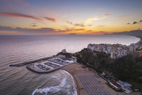Aerial view over the illuminated sea village of Sperlonga with the tower, the harbour and the mount Circeo in the background at dusk, Sperlonga, Latina province, Latium, Central Italy, Italy, Europe