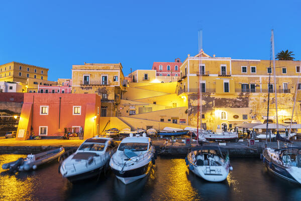 View of boats anchored in the water of the roman harbour of Ventotene village iluminated at dawn, Ventotene island, Pontine islands, Tyrrhenian sea, Mediterranean sea, Latium, central Italy, Italy, Southern Europe, Europe.