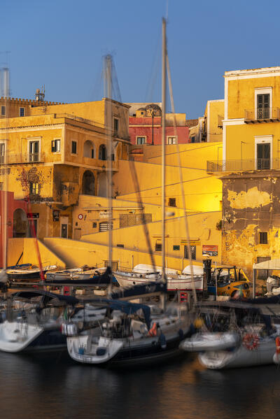 View of boats anchored in the water of the roman harbour of Ventotene village iluminated at dawn, Ventotene island, Pontine islands, Tyrrhenian sea, Mediterranean sea, Latium, central Italy, Italy, Southern Europe, Europe.